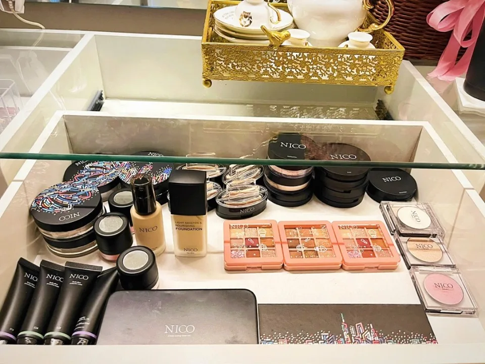 Drawer stocked with NICO foundation, powders, and an elegant tea set at DaBee Spa vanity